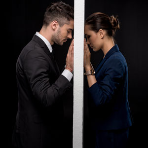 A couple shares an intimate gaze through a small hole - Yarbrough Law Firm