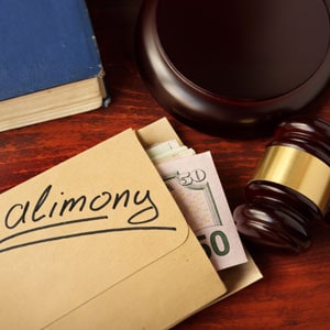 Dollars in envelope and a gavel - Yarbrough Law Firm